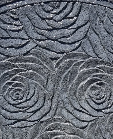 carving on rose wall close up