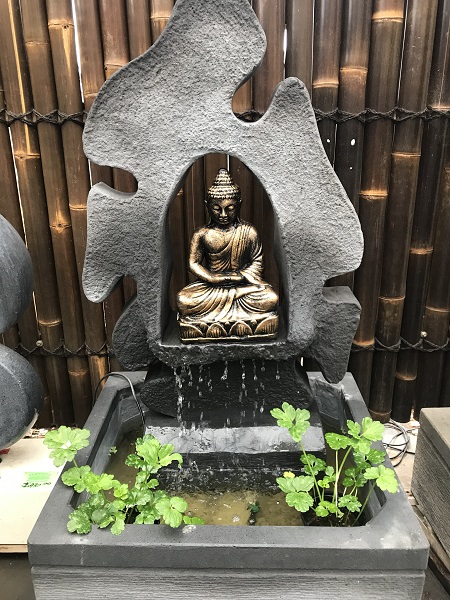 buddha in grotto water feature