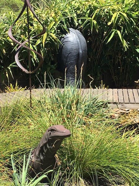 The back end of the life sized elephant in his new home.  The elephant bum is sitting amongst a bamboo forest with other statues