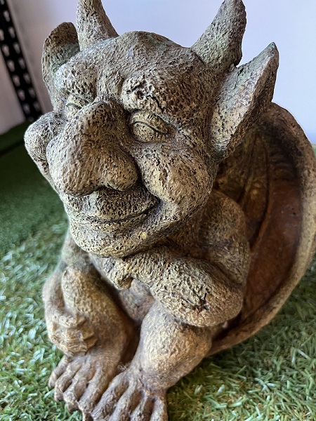 Small smiling gargoyle with horns
