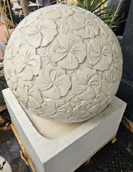 White ball water feature with hand carved hibiscus decoration