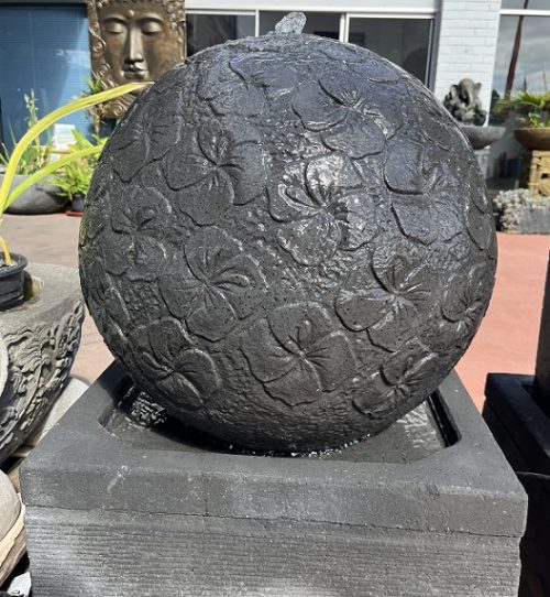 Ball water feature with hibiscus carving